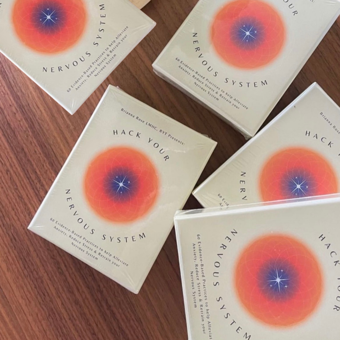 Books titled 'Hack Your Nervous System' on a wooden surface
